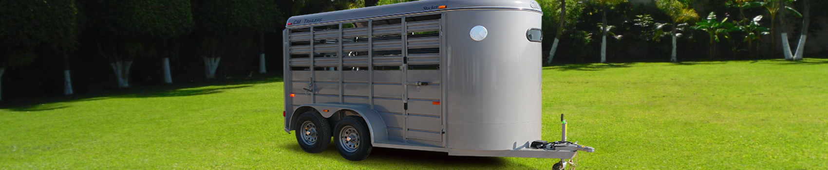 A 2017 CM Trailers Stocker trailer parked in the grass